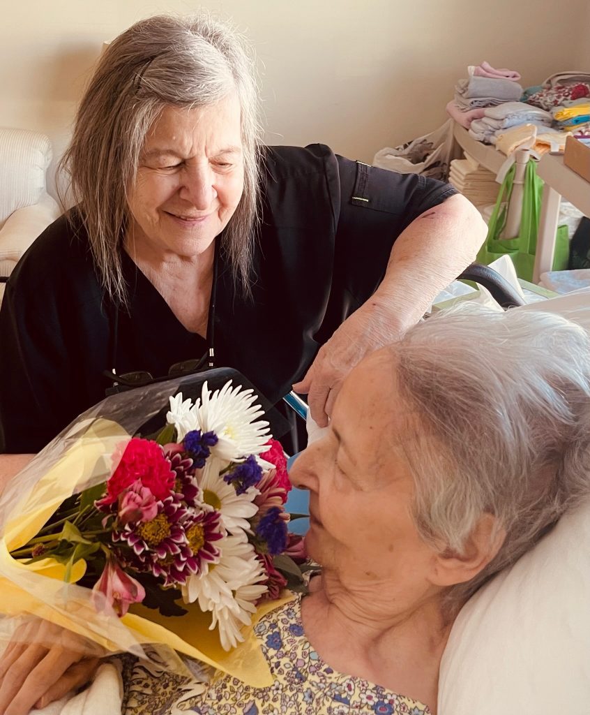 caregiver giving woman flowers