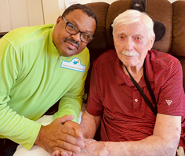 male caregiver caring for elderly man