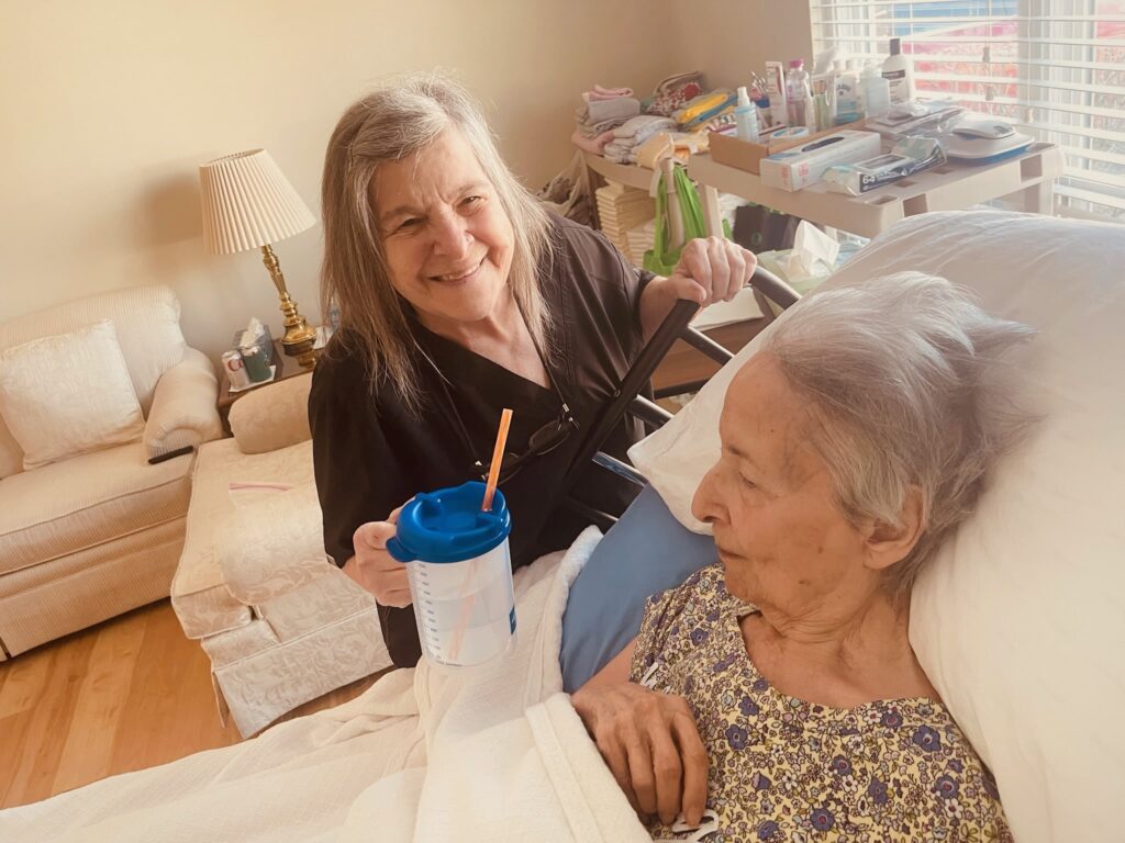 caregiver holding water cup